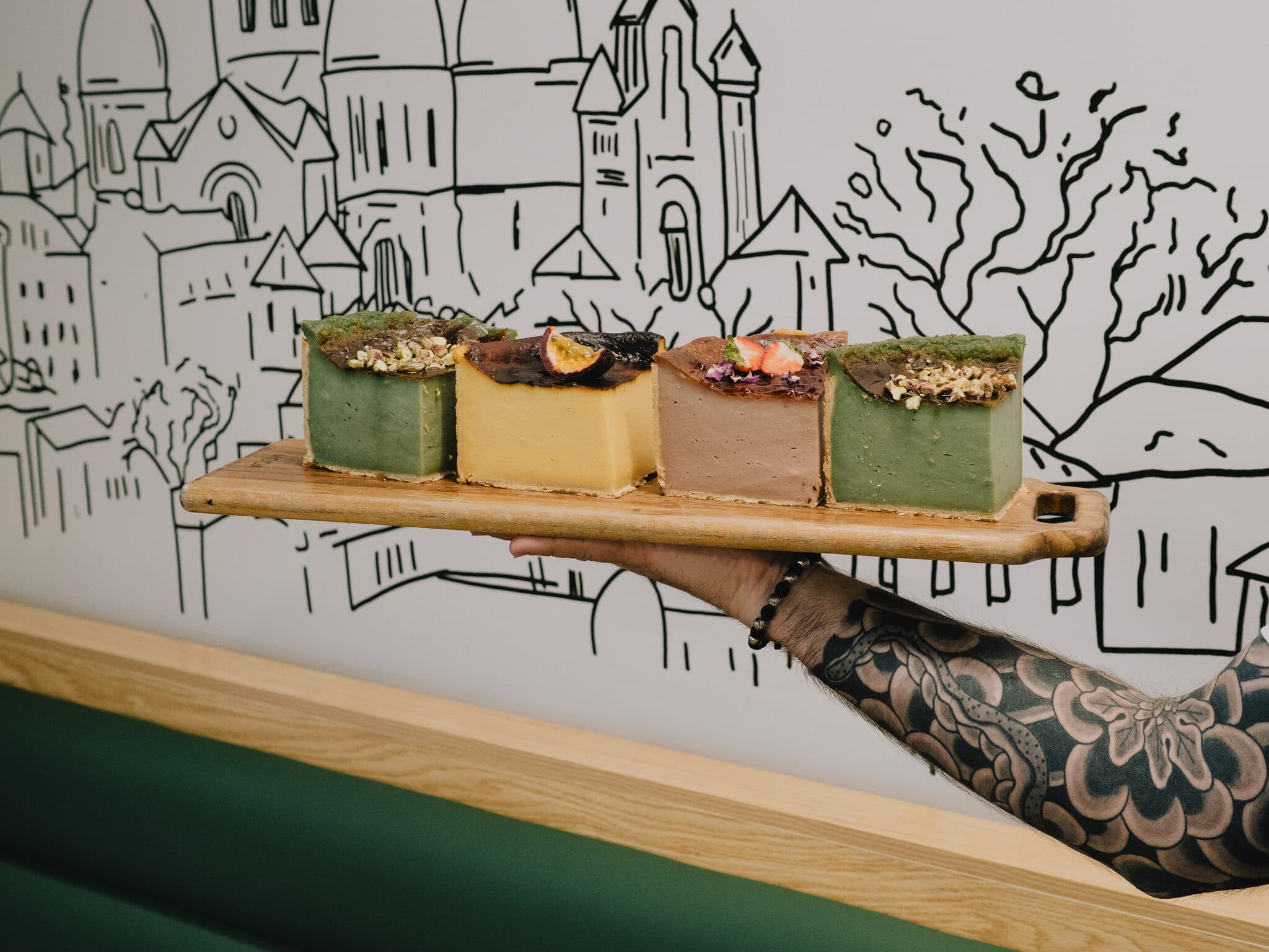 Four assorted Anaïs cake slices arranged on a board