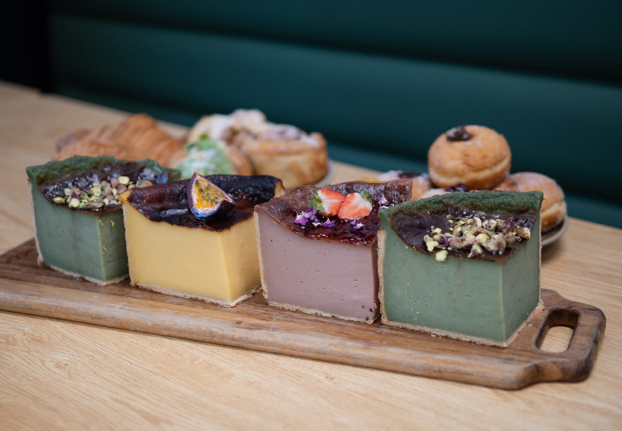 Dessert squares with assorted pastries behind