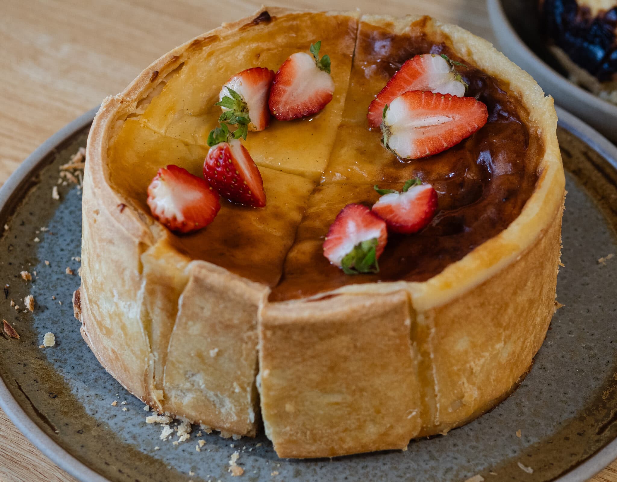 A close-up of a strawberry-topped Anaïs tart