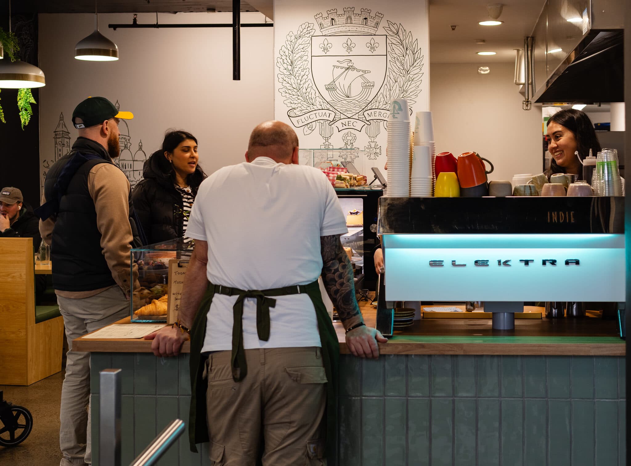The busy Anaïs counter with guests and the pastry display